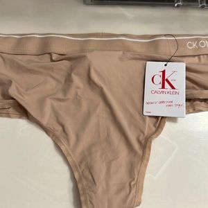 NWT XL Calvin Klein thong. Tan. Nylon, cotton gusset. No show.